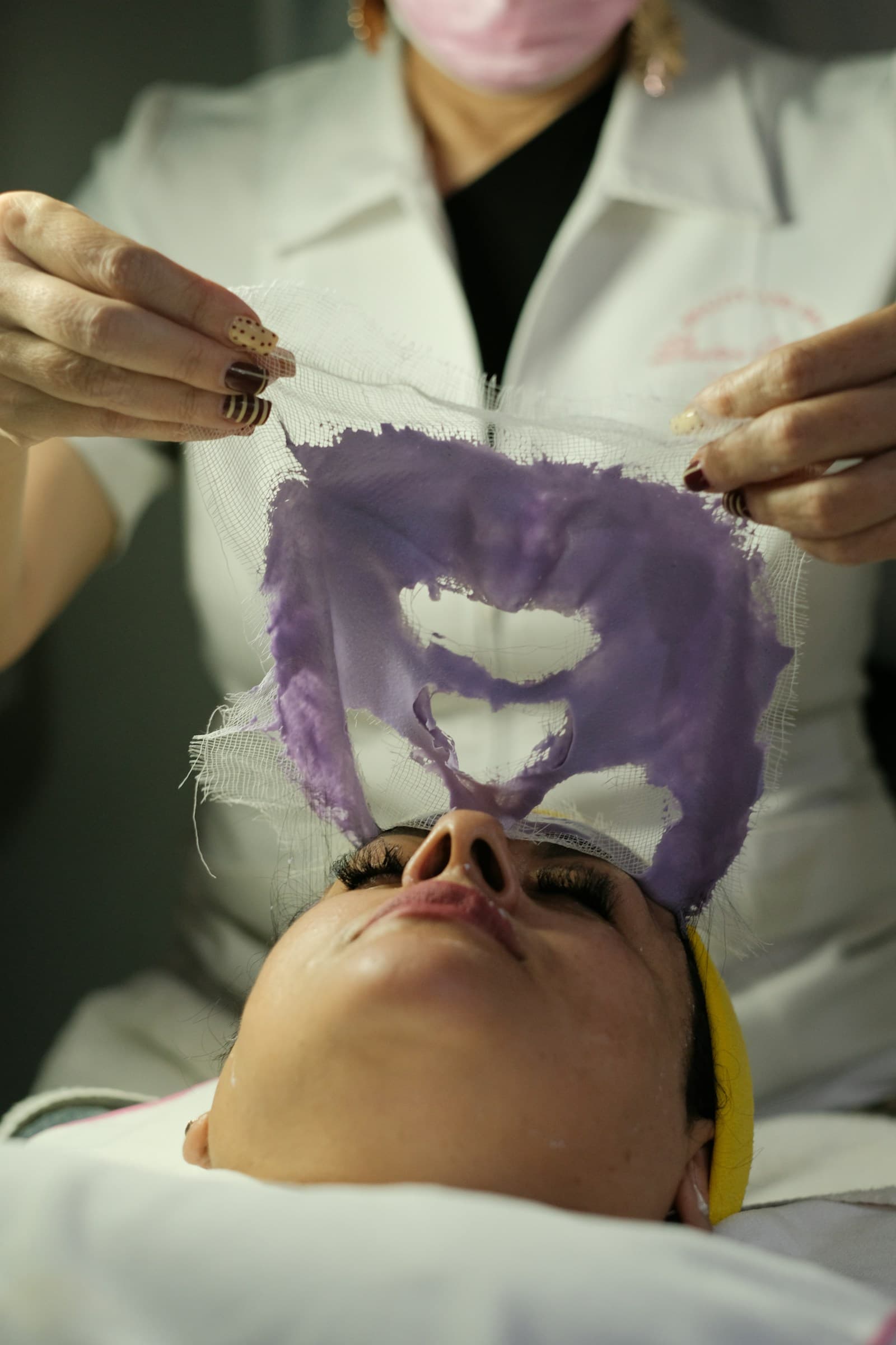 A practitioner preparing a facial rejuvenation treatment